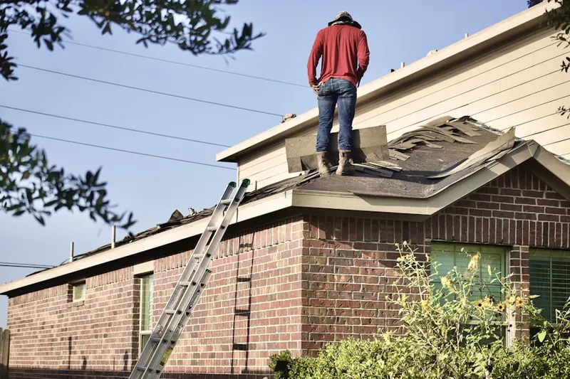 Professional roofer working on a residential roof in Pacific